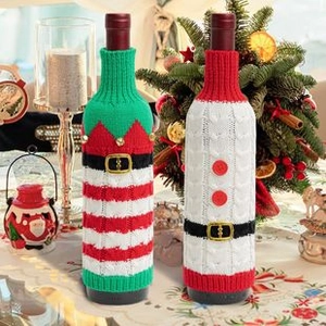 Close-up of knitted Christmas wine bottle covers with Santa and Elf holiday designs