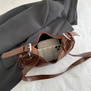 Brown glossy leather underarm bag with large capacity showing interior storage space