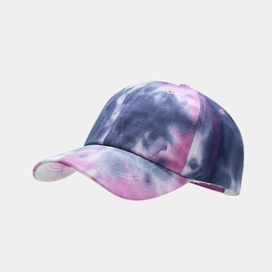 Detail of purple and pink tie-dye pattern on cotton baseball cap with neat stitching
