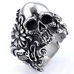Close-up of vintage punk skull ring with intricate floral carvings on stainless steel