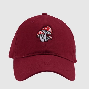 Detail of burgundy baseball cap featuring three red and white mushroom embroidery