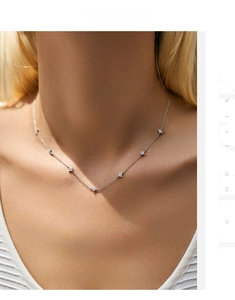 Detail of s925 sterling silver four-leaf clover necklace with sparkling zircon on model