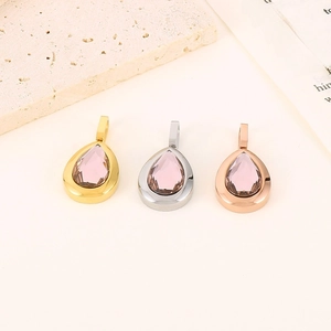 Detailed view of water-drop pendants in gold, silver, and rose gold with pink crystals