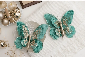 Detail of teal velvet double-layered butterfly ornament with gold glitter for Christmas DIY