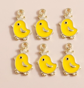 Detail of yellow enamel chick pendants with gold alloy crowns for DIY accessories