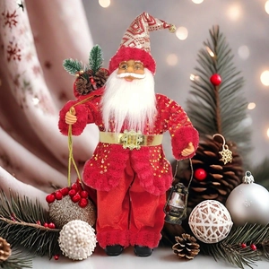 Detail of Santa Claus figure with gold sequins, vintage lantern and red gift bag