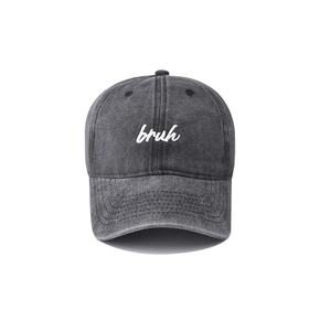 Detailed view of white bruh embroidery on washed dark gray vintage cotton baseball cap