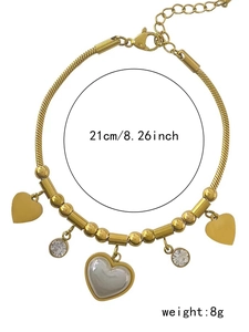 Detail view of heart beaded bracelet with white shell inlay and 21cm length scale