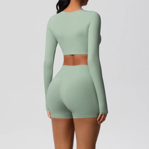 Back view of light green long sleeve crop top and high waist yoga shorts set