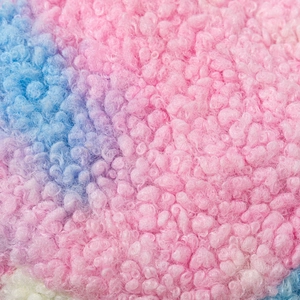 Macro detail of soft tie-dye faux fur fabric showing pink and purple plush textures