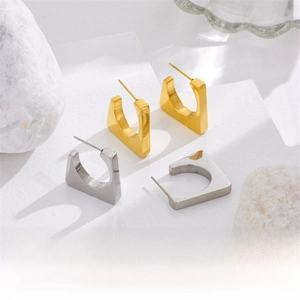 U-shaped square earrings in gold and silver finish on a clean aesthetic display