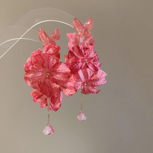 Detail of pink floral earrings with fabric petals and hanging lily of the valley pendants