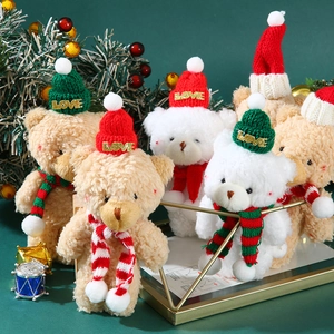 Detail of Christmas teddy bear plush pendants with knit hats and striped scarves