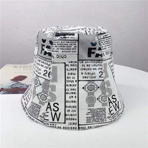 Detail view of newsprint pattern bucket hat made of durable black and white canvas fabric