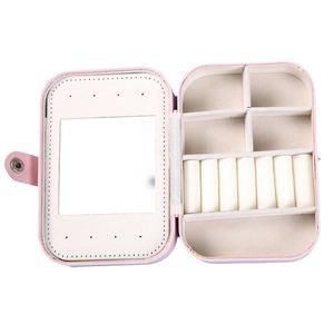 Pink multi-functional jewelry storage box with mirror and ring slots on white background