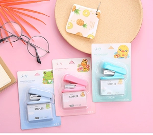 Macro detail of mini stapler set with cartoon packaging and refill staples for students