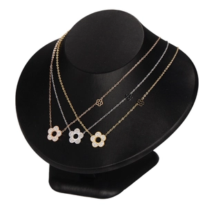 Floral zircon necklace set in gold, rose gold and silver finishes on black display stand
