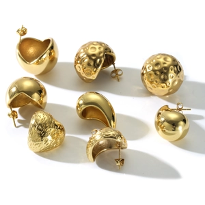 Golden stainless steel earrings in heart and textured sphere shapes on white background