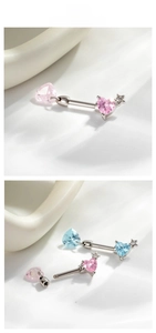 Detail showing heart-shaped zircon piercing with star accent and internal screw structure