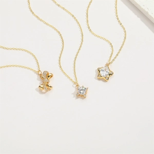 14K gold plated bow and star zircon pendant necklaces set on white background