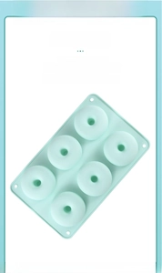 Detail of mint green 6-cavity silicone donut mold showing flexible material and texture