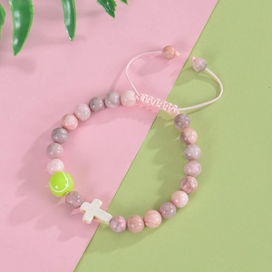 Pink zebra stone beaded bracelet with neon green tennis ball charm and cross bead
