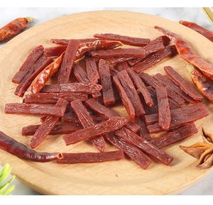 Macro detail of miniature PVC beef jerky strips with realistic texture on a wooden plate