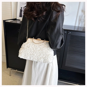 Detail view of the white 3D rose lace evening bag with pearl clasp and metal chain