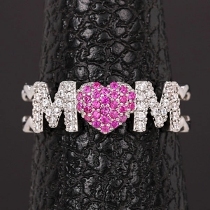 Macro shot of silver MOM ring with pink heart stone and pave set zircons details