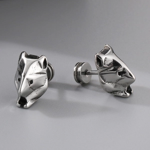 Detailed close-up of a silver wolf head earring in polished stainless steel