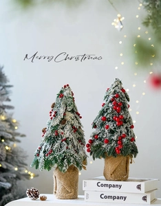 Mini cedar Christmas trees with red berries and snow flocking on burlap base