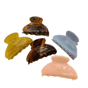Five-piece floral acetate hair claw set in amber, blue, and pink colors on white background