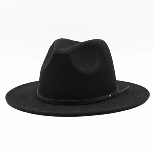 Close-up of classic black wool fedora with a slim leather band and gold stud detail