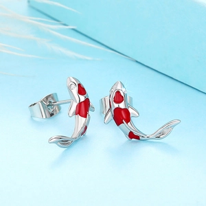 Detailed close-up of lucky koi fish stud earrings with red enamel and cubic zirconia