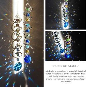 Macro view of crystal beads and blue faceted suncatcher sphere on metal spiral