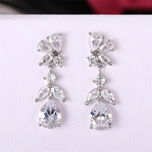 Macro view of teardrop crystal pendant with marquise zirconia flower on silver metal