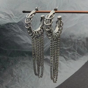 Elegant silver metallic multi-hoop earrings with long tassel chains on grey background