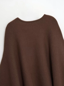 Close-up of coffee brown knit poncho showing neckline detail and textured fabric
