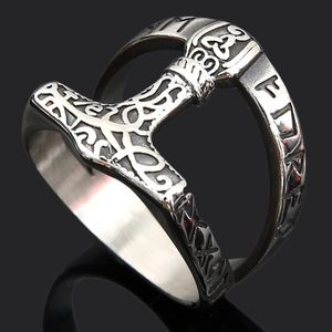 Detailed macro view of Viking Mjölnir ring with Nordic runes on silver stainless steel