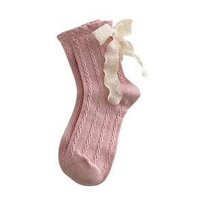 Pink knit mid-calf socks with white ribbon bows and vintage cable pattern