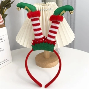 Detail of Christmas headband featuring striped elf legs and gold bells on a white lampshade