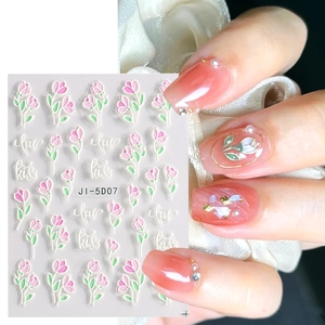 Detail of 5D embossed nail stickers featuring pink tulips and elegant floral patterns