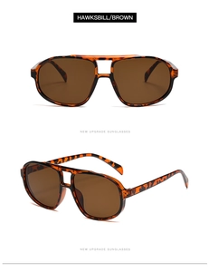 Detail of tortoise shell pilot sunglasses with brown lenses and thick frames