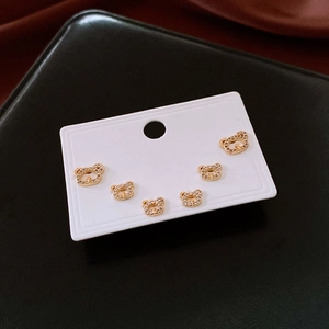 Macro view of gold plated bear earrings with sparkling cubic zirconia on a white card