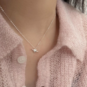 Minimalist S925 silver heart saturn necklace worn on a soft pink sweater model
