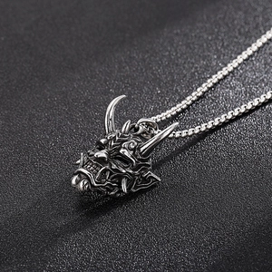 Detailed macro view of silver punk ghost mask pendant with sharp horns and fangs