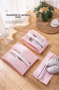 Three pink semi-transparent waterproof shoe storage bags in different sizes on wood floor