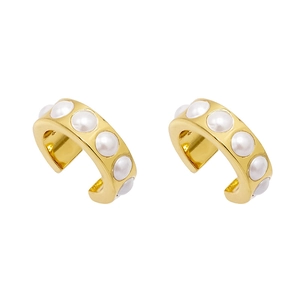 Detail view of 18K gold clip-on earrings with elegant inlaid pearls and vintage C-shaped design