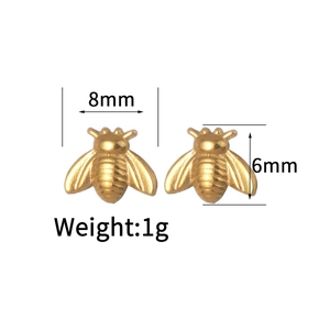 Detailed view of gold bee stud earrings with 8mm x 6mm dimensions and 1g weight