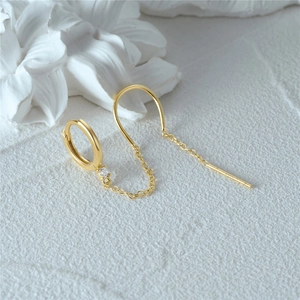 Detail of S925 sterling silver earring with gold chain and white zircon inlay